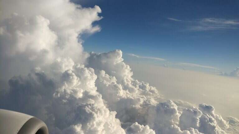 View of clouds from an aircraft window during a long-haul flight