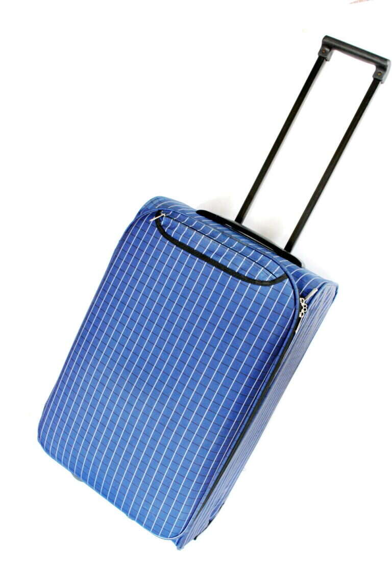 A soft-sided cloth suitcase packed for travel